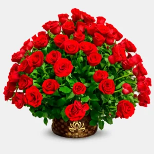 "Gran arreglo floral Eternal Love con docenas de rosas rojas frescas y follaje verde en una base de canasta tejida de Milliers D'fleurs."